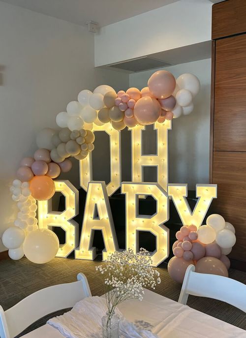 Timeless Party Rentals wedding photo with 'Oh Baby' sign