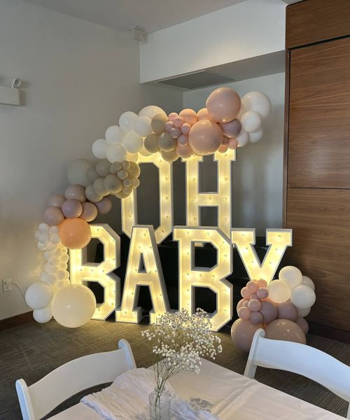 Timeless Party Rentals wedding photo with 'Oh Baby' sign